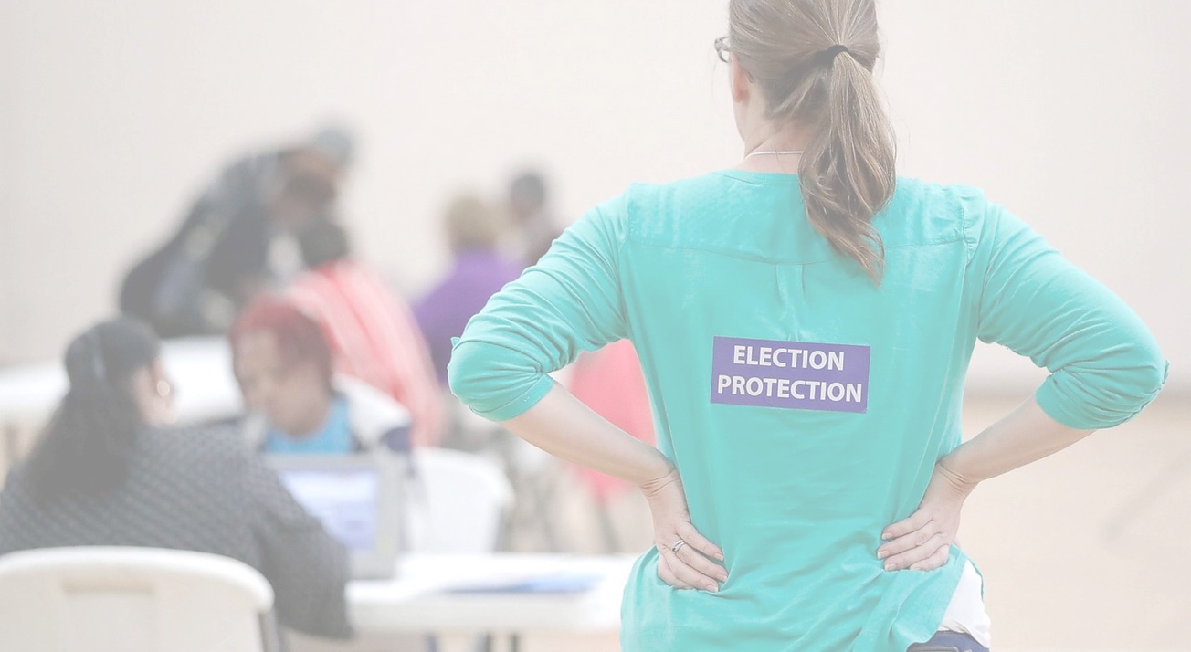 An election protection volunteer supporting voters at a community table
