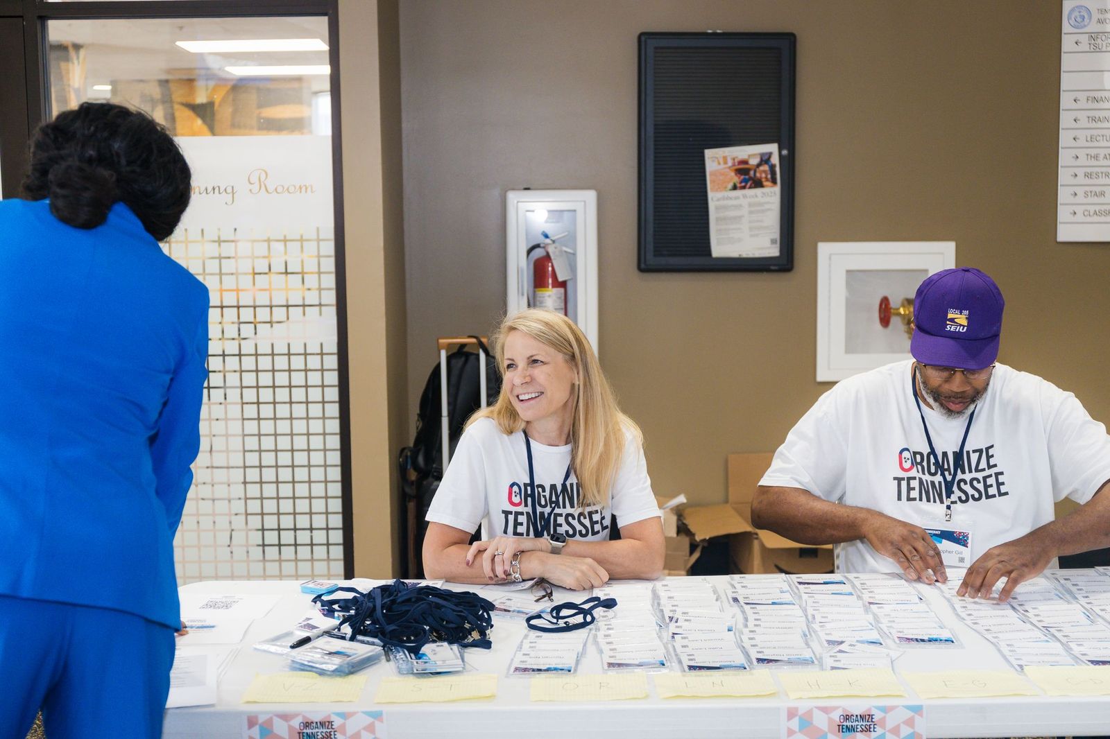 Organize Tennessee volunteers welcoming attendees at the Democracy Summit registration table